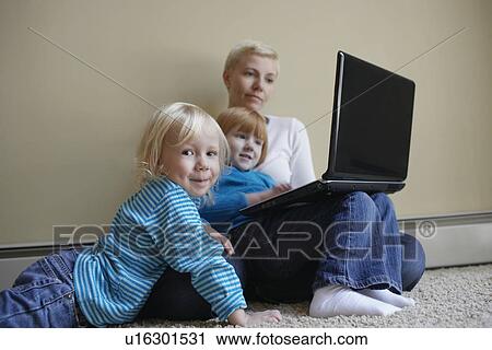 Mother with two daughters (3-6) using laptop on floor View Large Photo Image Stock Image - Mother with two daughters (3-6) using laptop on floor. Fotosearch