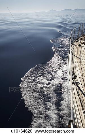 Stock Image - Mountain shore from sailboat deck. Fotosearch