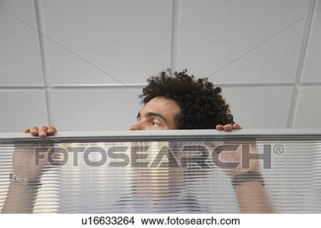 Office worker peering over cubicle wall View Large Photo Image Picture - Office worker peering over cubicle wall. Fotosearch