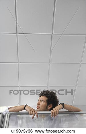 Office worker peering over cubicle wall View Large Photo Image Stock Photograph - Office worker peering over cubicle wall. Fotosearch