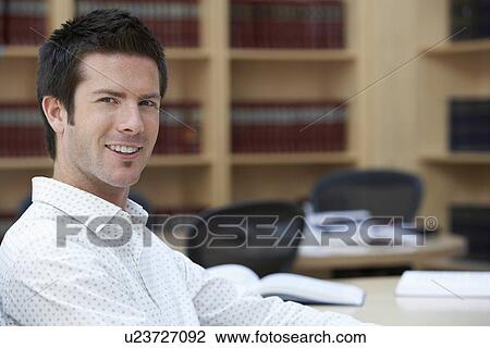 Office worker sitting in office portrait View Large Photo Image Stock Image - Office worker sitting in office portrait. Fotosearch