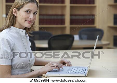 Office worker using laptop in legal office portrait View Large Photo Image Picture - Office worker using laptop in legal office portrait. Fotosearch
