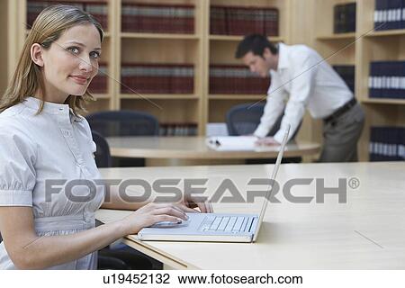 Office worker using laptop in legal office portrait View Large Photo Image Stock Image - Office worker using laptop in legal office portrait. Fotosearch
