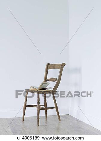 Open book on chair in empty room corner View Large Photo Image Stock Photo - Open book on chair in empty room corner. Fotosearch