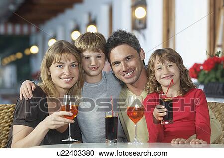 Parents and children (7-9) with drinks at restaurant portrait View Large Photo Image Stock Image - Parents and children (7-9) with drinks at restaurant portrait. Fotosearch