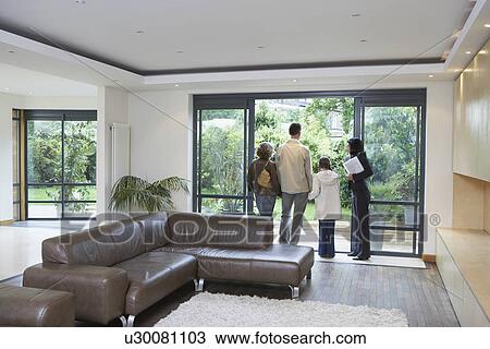 Parents and daughter (7-9) with estate agent observing new property View Large Photo Image Stock Image - Parents and daughter (7-9) with estate agent observing new property. Fotosearch