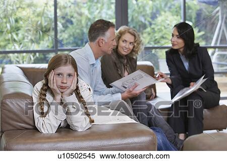 Parents with bored daughter (7-9) and estate agent discussing new property View Large Photo Image Stock Photography - Parents with bored daughter (7-9) and estate agent discussing new property. Fotosearch