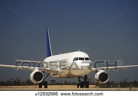 Passenger jet on taxiway View Large Photo Image Stock Photograph - Passenger jet on taxiway. Fotosearch