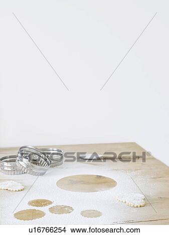 Picture - Pastry cutters and flour on table top. Fotosearch