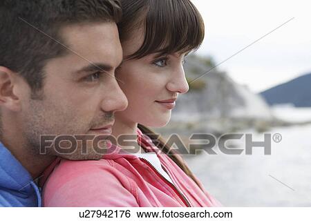 Pensive couple at ocean close-up View Large Photo Image Stock Photograph - Pensive couple at ocean close-up. Fotosearch