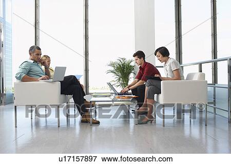 People sitting in modern waiting room two using laptops View Large Photo Image Stock Photo - People sitting in modern waiting room two using laptops. Fotosearch