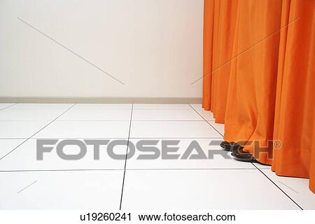 Person hiding behind orange curtain View Large Photo Image Stock Image - Person hiding behind orange curtain. Fotosearch