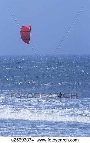 Picture - Person kitesurfing in sea. Fotosearch
