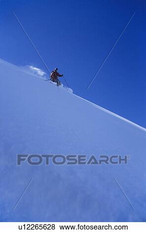 Person skiing down slope side view View Large Photo Image Stock Photo - Person skiing down slope side view. Fotosearch