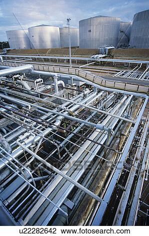 Petrochemical oil refinery storage tanks and pipes View Large Photo Image Stock Image - Petrochemical oil refinery storage tanks and pipes. Fotosearch