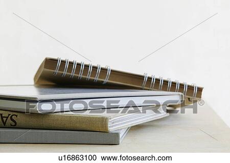 Stock Image - Pile of note books close up studio shot. Fotosearch
