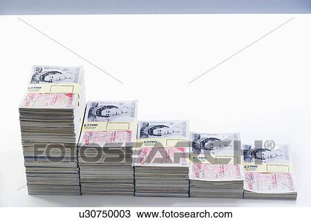 Stock Image - Piles of sealed pound banknotes. Fotosearch