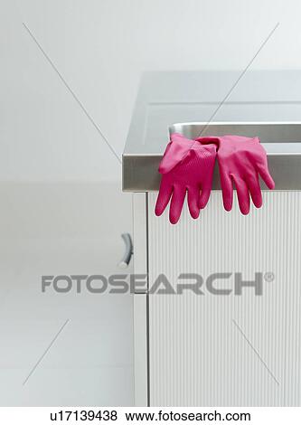 Pink rubber gloves on edge of sink View Large Photo Image Stock Photo - Pink rubber gloves on edge of sink. Fotosearch