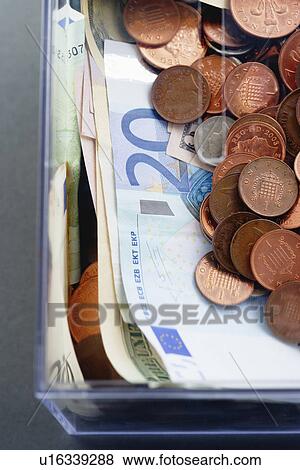 Plastic moneybox with Coins and paper Euro currency view from above View Large Photo Image Stock Photo - Plastic moneybox with Coins and paper Euro currency view from above. Fotosearch