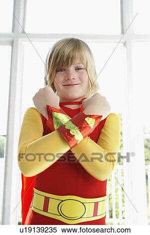 Portrait of boy (7-9) wearing superhero costume arms crossed smiling View Large Photo Image Stock Photography - Portrait of boy (7-9) wearing superhero costume arms crossed smiling. Fotosearch