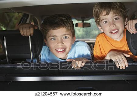 Portrait of boys (6-11) in car interior smiling View Large Photo Image Stock Photo - Portrait of boys (6-11) in car interior smiling. Fotosearch