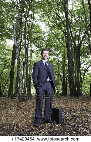 Portrait of business man in forest hands in pockets View Large Photo Image Picture - Portrait of business man in forest hands in pockets. Fotosearch