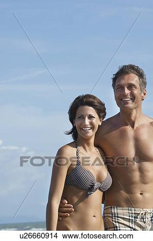 Picture - Portrait of couple on beach laughing. Fotosearch
