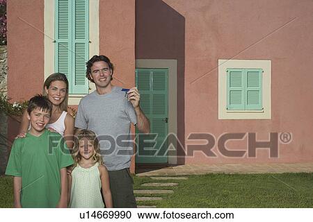 Portrait of family with two children (6-11) in front of house View Large Photo Image Stock Image - Portrait of family with two children (6-11) in front of house. Fotosearch