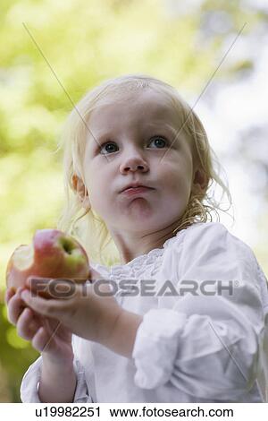 Portrait of girl (1-2) eating apple View Large Photo Image Stock Image - Portrait of girl (1-2) eating apple. Fotosearch