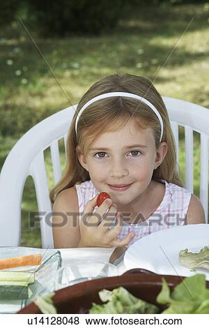 Portrait of girl (5-6) sitting at dinner table in garden View Large Photo Image Stock Photo - Portrait of girl (5-6) sitting at dinner table in garden. Fotosearch