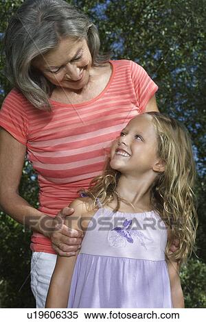 Stock Photography - Portrait of grandmother and granddaughter (5-6) looking in eyes. Fotosearch
