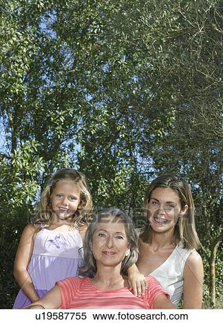 Portrait of grandmother mother and daughter (5-6) in garden View Large Photo Image Stock Photography - Portrait of grandmother mother and daughter (5-6) in garden. Fotosearch