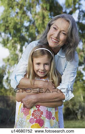 Portrait of grandmother with granddaughter (5-6) smiling View Large Photo Image Stock Image - Portrait of grandmother with granddaughter (5-6) smiling. Fotosearch