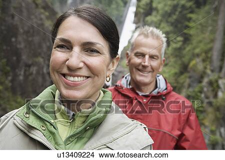 Portrait of man and woman smiling waterfall in background View Large Photo Image Picture - Portrait of man and woman smiling waterfall in background. Fotosearch