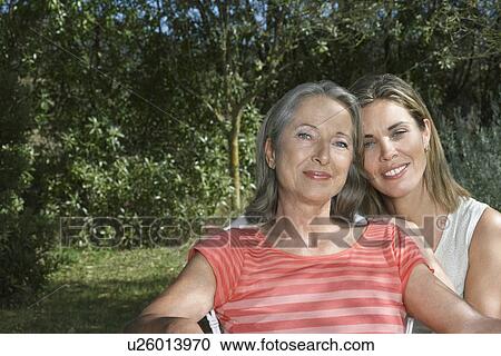 Portrait of mother with adult daughter in garden View Large Photo Image Stock Image - Portrait of mother with adult daughter in garden. Fotosearch