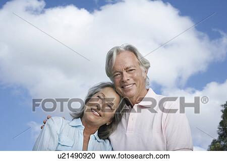 Portrait of senior couple against sky smiling View Large Photo Image Stock Image - Portrait of senior couple against sky smiling. Fotosearch