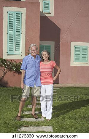 Portrait of senior couple in front of house View Large Photo Image Stock Image - Portrait of senior couple in front of house. Fotosearch