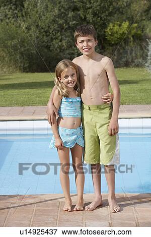 Portrait of sister and brother (6-11) by pool smiling View Large Photo Image Stock Photo - Portrait of sister and brother (6-11) by pool smiling. Fotosearch