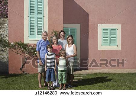 Portrait of three-generation family with two children (6-9) in front of house View Large Photo Image Stock Image - Portrait of three-generation family with two children (6-9) in front of house. Fotosearch