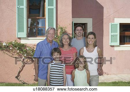 Portrait of three-generation family with two children (6-9) in front of house View Large Photo Image Stock Photo - Portrait of three-generation family with two children (6-9) in front of house. Fotosearch
