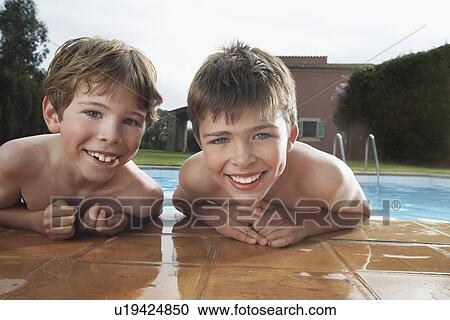 Portrait of two boys (6-11) leaning on edge of pool View Large Photo Image Stock Image - Portrait of two boys (6-11) leaning on edge of pool. Fotosearch