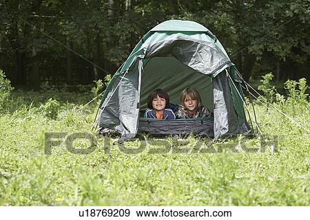 Stock Photo - Portrait of two boys (7-9) lying in tent. Fotosearch