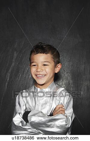Portrait of young boy (5-6) in silver costume arms crossed smiling studio shot View Large Photo Image Stock Photograph - Portrait of young boy (5-6) in silver costume arms crossed smiling studio shot. Fotosearch