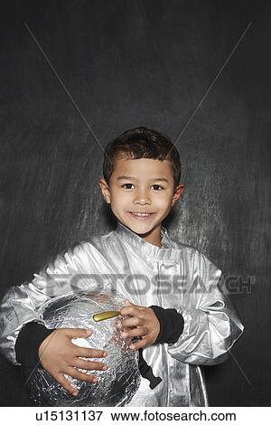 Portrait of young boy (5-6) in astronaut costume holding helmet smiling studio shot View Large Photo Image Stock Photo - Portrait of young boy (5-6) in astronaut costume holding helmet smiling studio shot. Fotosearch