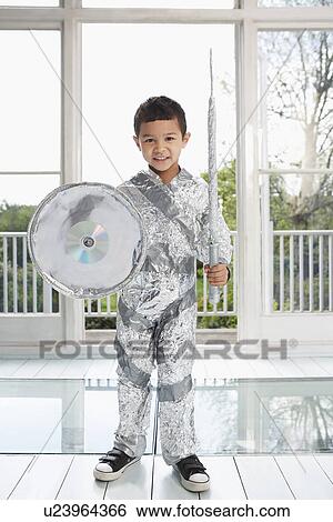 Portrait of young boy (5-6) posing in aluminum foil knight costume indoors View Large Photo Image Stock Photograph - Portrait of young boy (5-6) posing in aluminum foil knight costume indoors. Fotosearch
