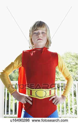 Portrait of young boy (7-9) in superhero costume hands on hip View Large Photo Image Stock Photograph - Portrait of young boy (7-9) in superhero costume hands on hip. Fotosearch