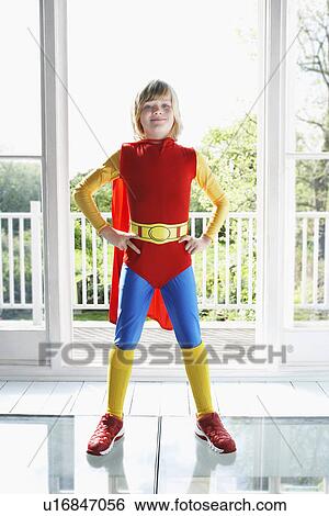 Portrait of young boy (7-9) posing in superhero costume with hands on hip View Large Photo Image Stock Photograph - Portrait of young boy (7-9) posing in superhero costume with hands on hip. Fotosearch