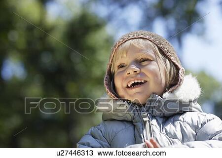 Portrait of young girl (3-4) in winter clothes laughing View Large Photo Image Stock Image - Portrait of young girl (3-4) in winter clothes laughing. Fotosearch