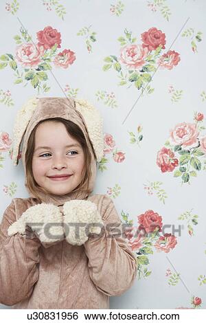 Portrait of young girl (5-6) in bunny costume against wallpaper with floral pattern View Large Photo Image Stock Photograph - Portrait of young girl (5-6) in bunny costume against wallpaper with floral pattern. Fotosearch