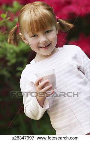 Portrait of young girl (5-6) with glass of smoothie smiling View Large Photo Image Stock Photo - Portrait of young girl (5-6) with glass of smoothie smiling. Fotosearch